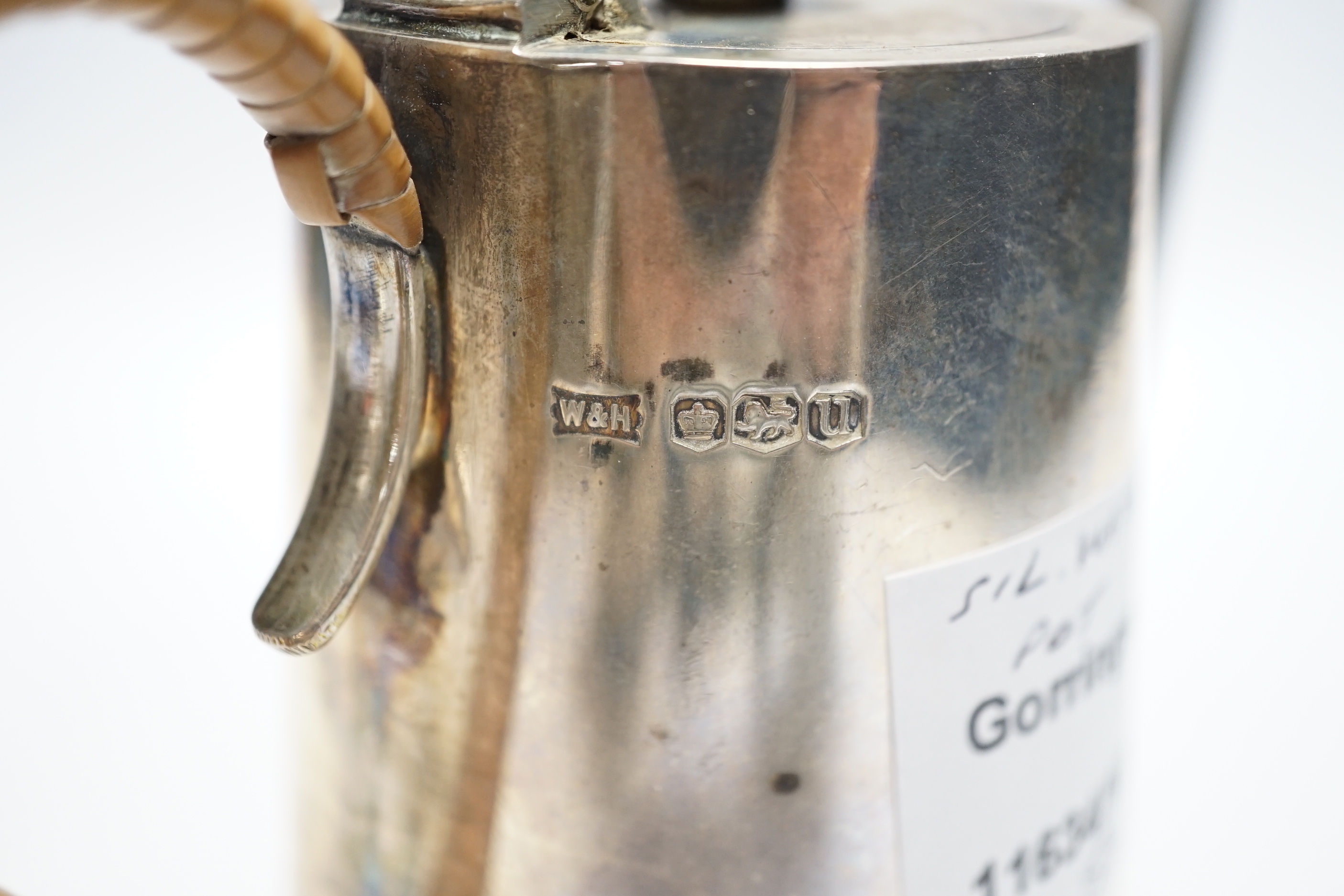 A George VI silver hot water pot, with rattan handle, Walker & Hall, Sheffield, 1937, height 15.7cm, gross weight 10.2oz.